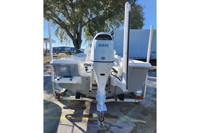 Slide: The Image of 2022 Bulls Bay 2000 boat with 140 HP outboard motor, parked outdoors. - 7