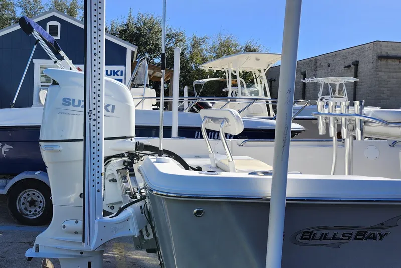 Slide: The Image of Bulls Bay 2000 boat with Suzuki engine, parked outdoors, 2022 model. - 8