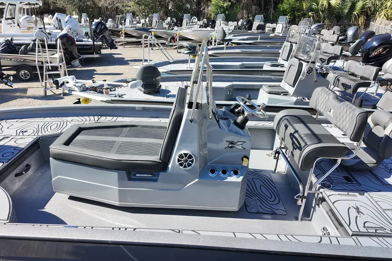 Slide: The Image of 2026 Xpress X23B Bay Lounge boat with sleek seating and modern design in a showroom. - 18