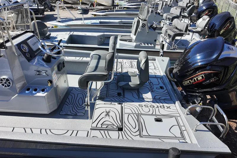 Slide: The Image of 2026 Xpress X23B Bay Lounge boat with modern seating and powerful engine. - 19