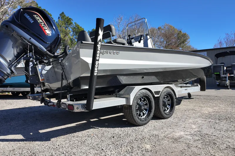 Slide: The Image of 2026 Xpress X23B Bay Lounge boat on trailer with Yamaha engine, parked outdoors. - 3