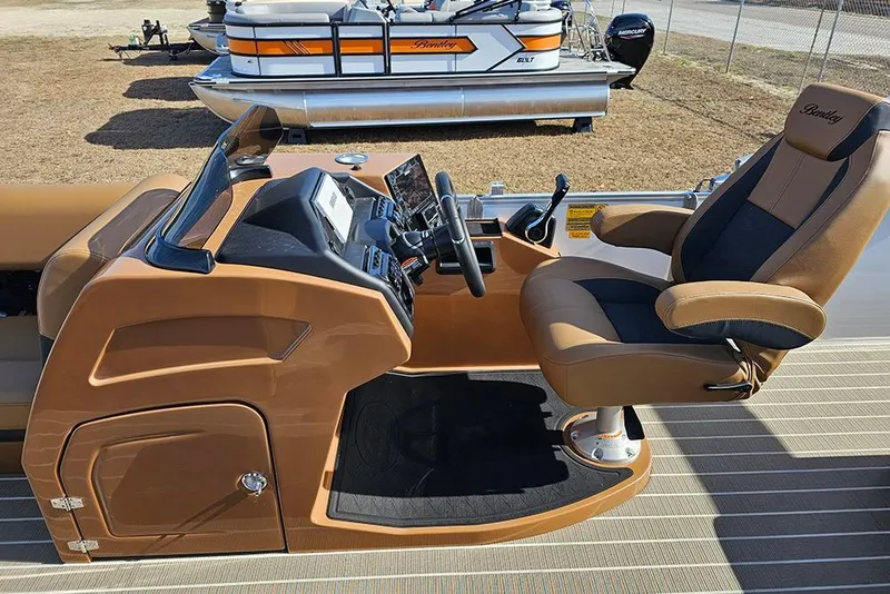Slide: The Image of 2023 Bentley Pontoons 223 Elite Swingback DC helm with luxurious captain's chair and controls. - 20