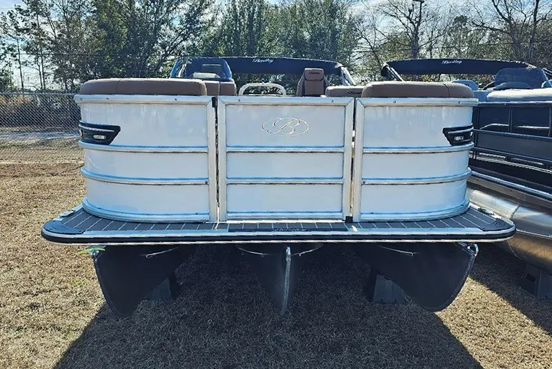 Slide: The Image of 2023 Bentley Pontoons 223 Elite Swingback DC, rear view, parked on grass. - 5