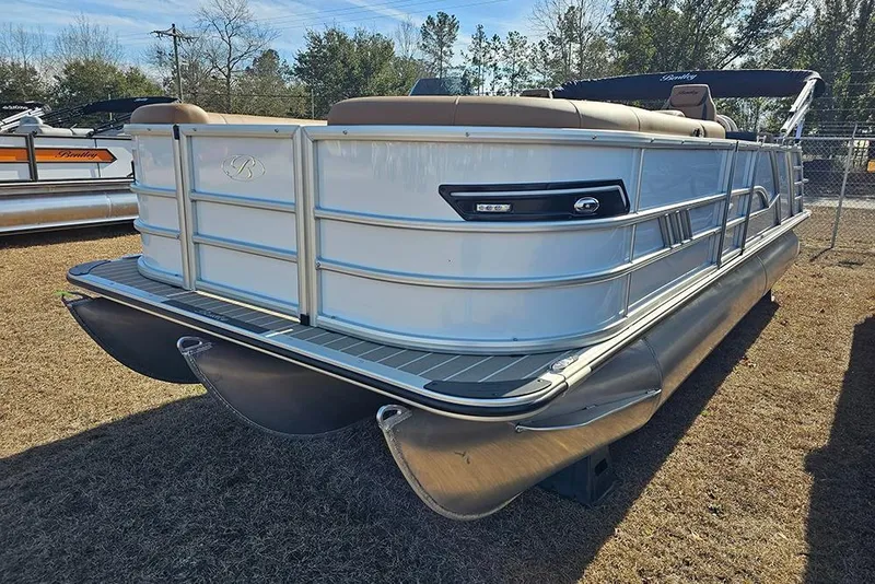 Slide: The Image of 2023 Bentley Pontoons 223 Elite Swingback DC, sleek design, parked on grass. - 6