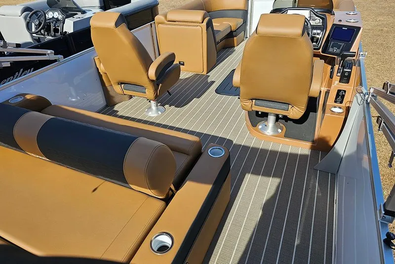Slide: The Image of 2023 Bentley Pontoons 223 Elite Swingback DC interior with tan seating and modern dashboard. - 9