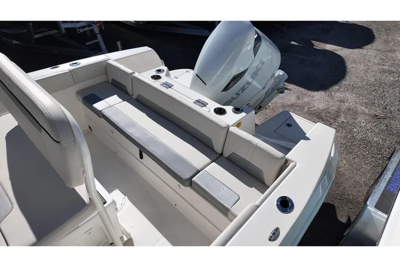Slide: The Image of 2026 Sailfish 232 CC boat interior with seating and Suzuki outboard motor. - 13