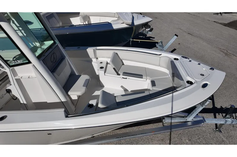 Slide: The Image of 2026 Sailfish 232 CC boat interior with seating and console, on a trailer. - 18