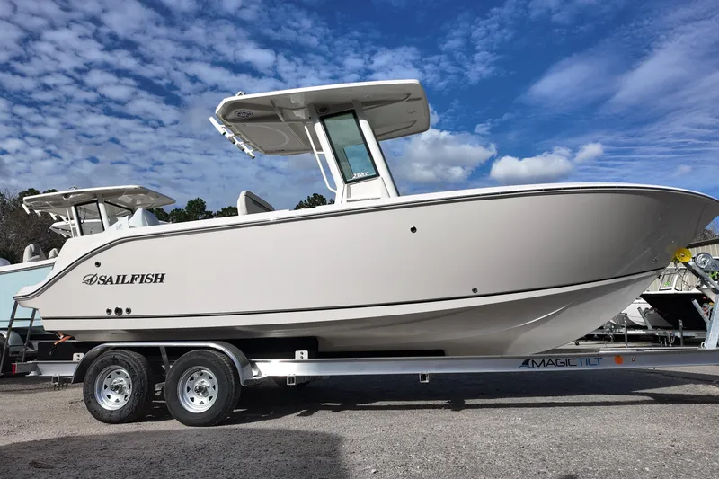 Slide: The Image of 2026 Sailfish 232 CC boat on trailer under blue sky. - 2