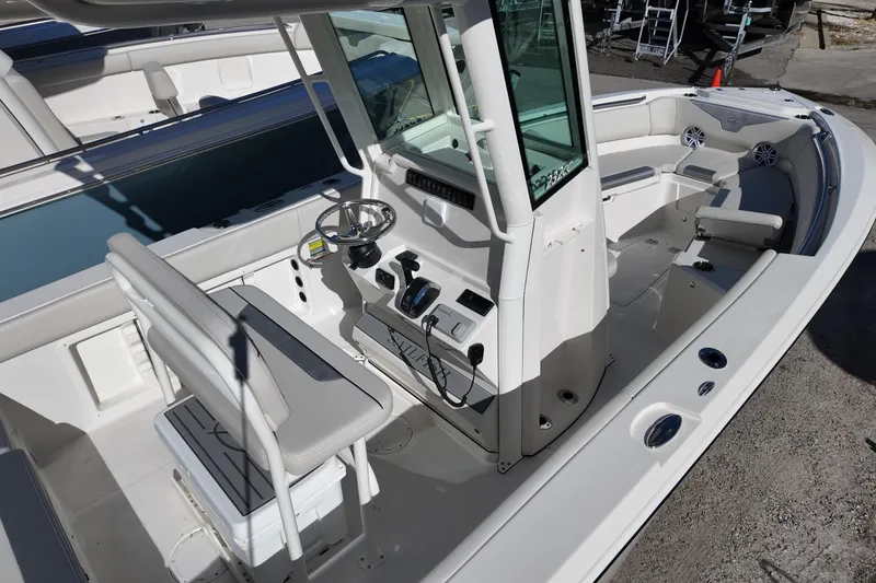 Slide: The Image of 2026 Sailfish 232 CC boat interior with helm, seating, and modern controls. - 5