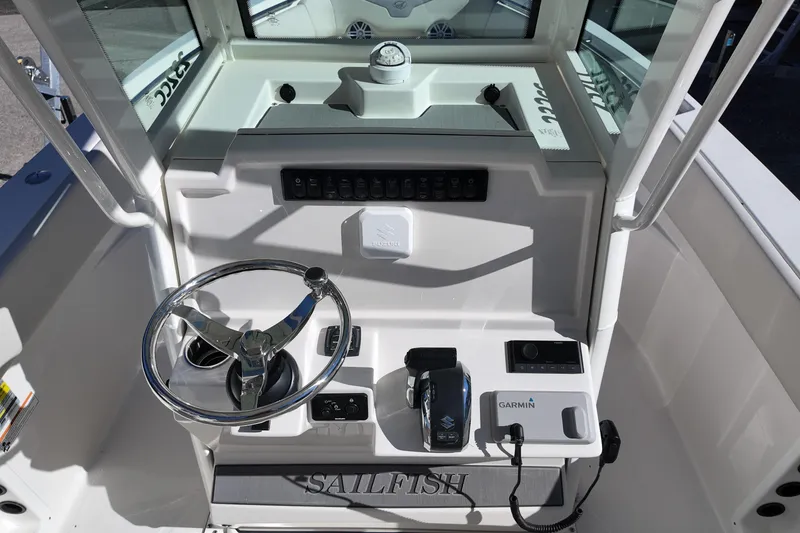 Slide: The Image of 2026 Sailfish 232 CC boat console with steering wheel and Garmin navigation system. - 6