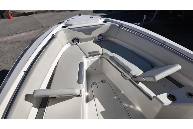 Slide: The Image of 2026 Sailfish 232 CC boat interior with cushioned seating and cup holders. - 8