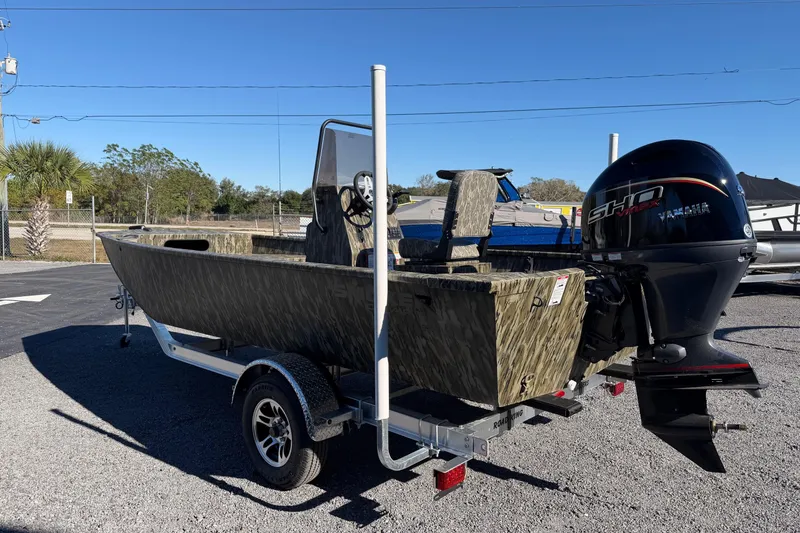 Slide: The Image of 2026 Smoker Craft Sportsman 1866 boat with Yamaha engine on trailer, outdoors. - 3