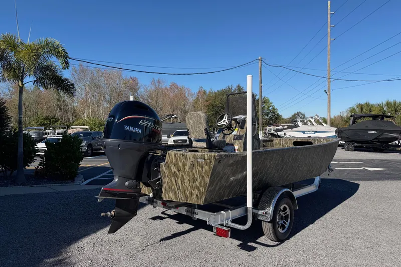 Slide: The Image of 2026 Smoker Craft Sportsman 1866 boat with Yamaha engine on trailer, parked outdoors. - 4