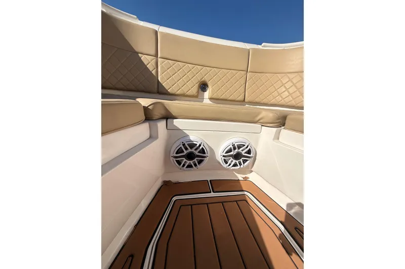 Slide: The Image of Interior of 2019 Intrepid 345 Nomad FE boat with tan seating and speakers. - 12