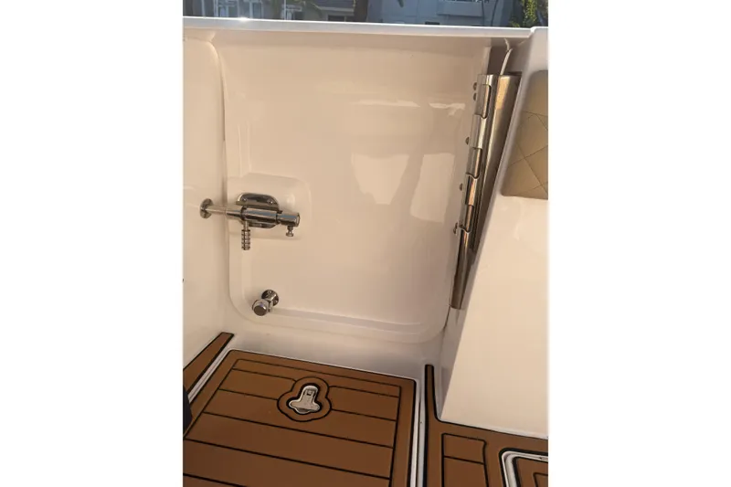 Slide: The Image of 2019 Intrepid 345 Nomad FE boat interior with teak flooring and stainless steel hardware. - 15