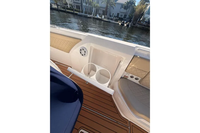 Slide: The Image of 2019 Intrepid 345 Nomad FE boat interior with cup holders and teak flooring. - 16