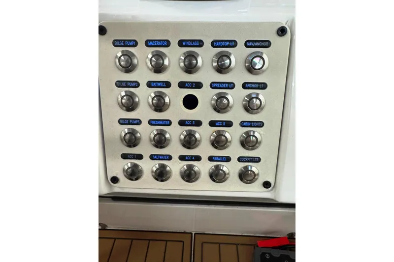 Slide: The Image of Control panel of a 2019 Intrepid 345 Nomad FE boat with labeled switches. - 17