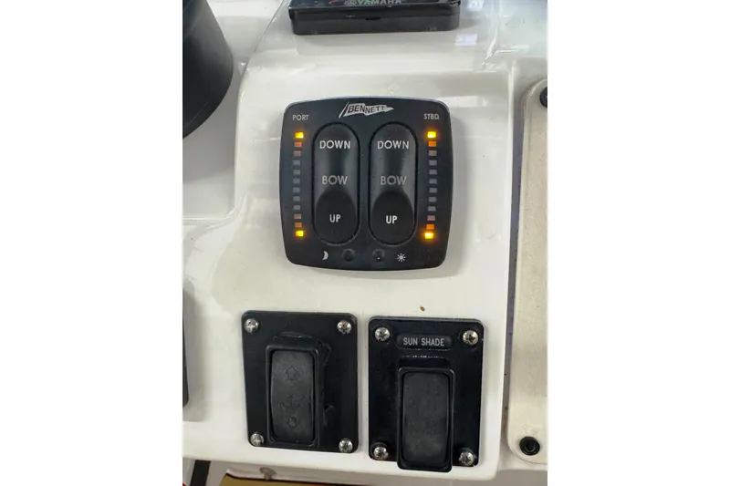 Slide: The Image of Control panel of a 2019 Intrepid 345 Nomad FE boat with trim tab switches. - 18