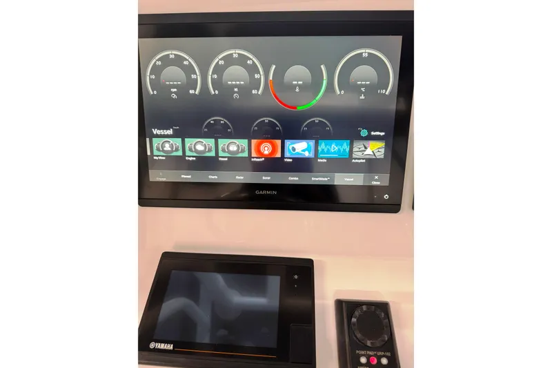 Slide: The Image of Garmin and Yamaha displays on 2019 Intrepid 345 Nomad FE boat dashboard. - 20