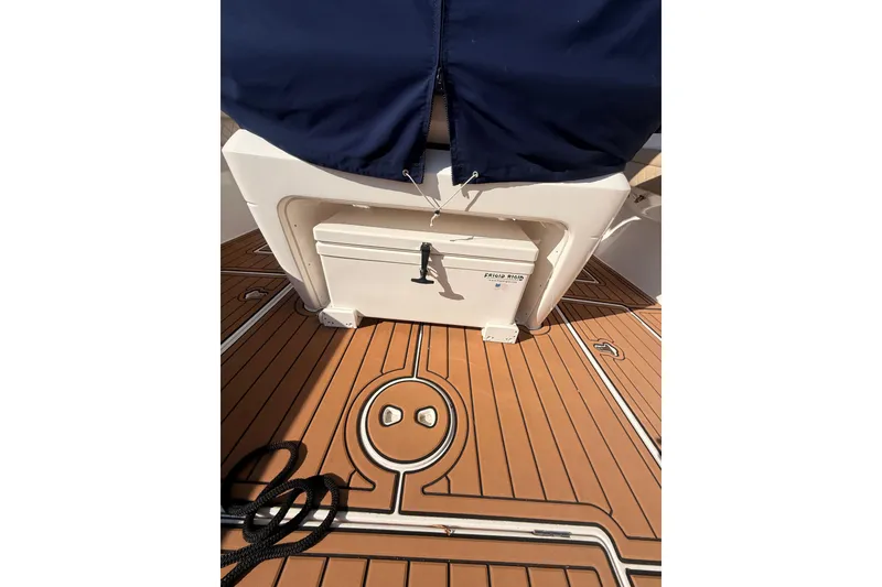 Slide: The Image of 2019 Intrepid 345 Nomad FE boat deck with storage compartment and rope. - 24