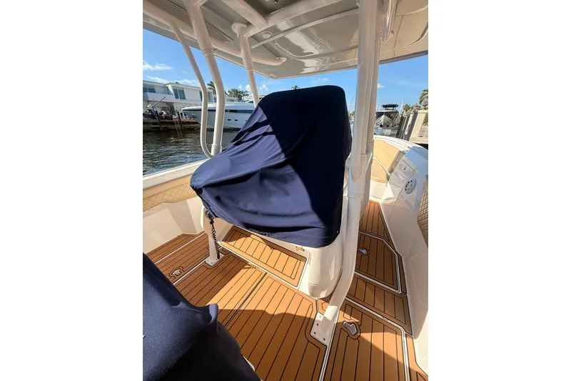 Slide: The Image of 2019 Intrepid 345 Nomad FE boat interior with covered seating and teak flooring. - 25