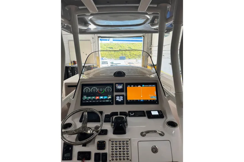 Slide: The Image of 2019 Intrepid 345 Nomad FE boat dashboard with modern navigation displays. - 3