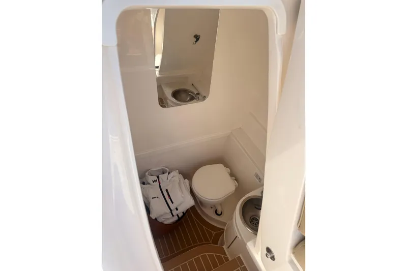 Slide: The Image of 2019 Intrepid 345 Nomad FE boat bathroom with sink and toilet. - 33