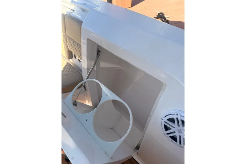Slide: The Image of 2019 Intrepid 345 Nomad FE boat interior with cup holders and speaker. - 34