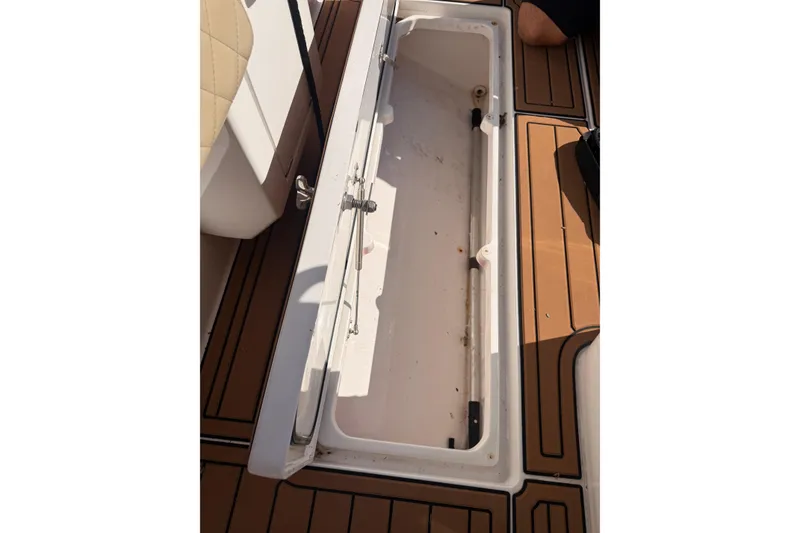 Slide: The Image of 2019 Intrepid 345 Nomad FE boat with elegant seating and teak flooring, docked under clear skies. - 37