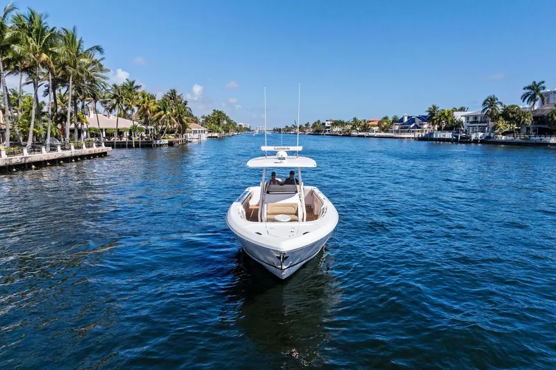 Slide: The Image of 2019 Intrepid 345 Nomad FE boat interior with tan seating and wooden deck. - 42