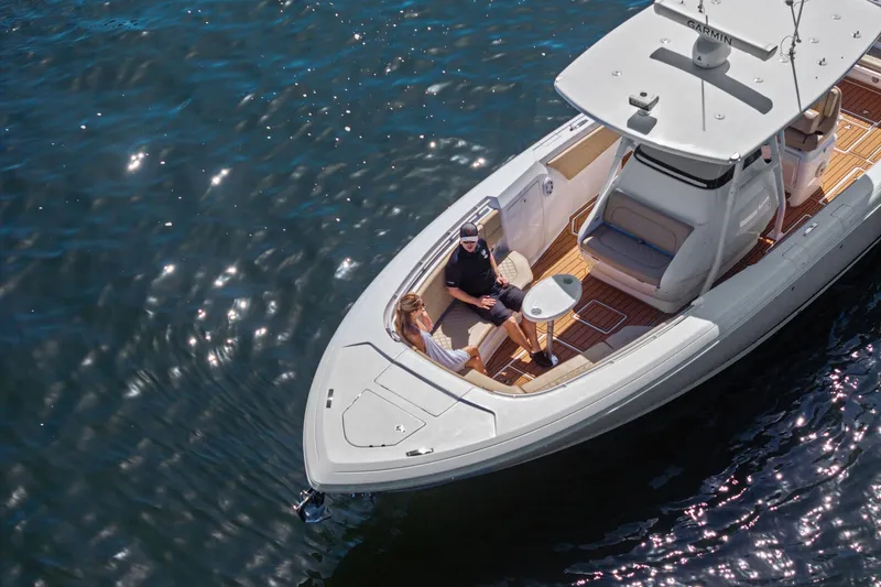 Slide: The Image of Open storage compartment on 2019 Intrepid 345 Nomad FE boat, featuring teak-style flooring. - 46