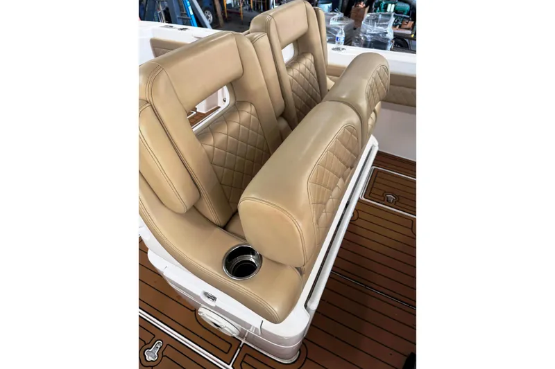 Slide: The Image of Luxurious tan seating on 2019 Intrepid 345 Nomad FE boat with diamond stitching and cup holder. - 5