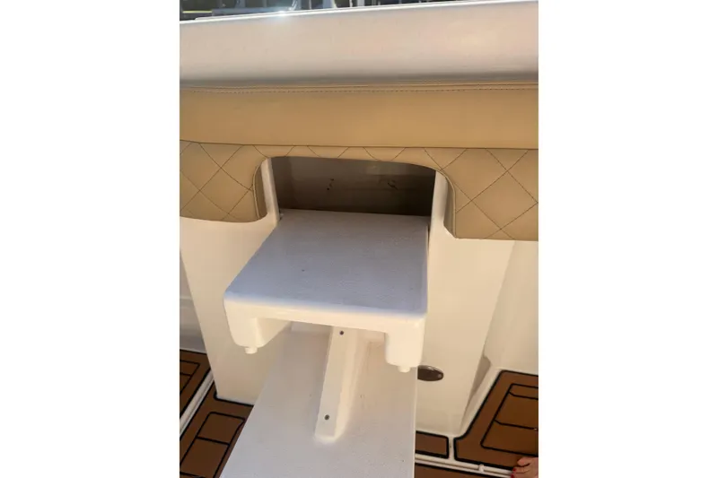 Slide: The Image of 2019 Intrepid 345 Nomad FE boat interior with cushioned seating and step detail. - 7