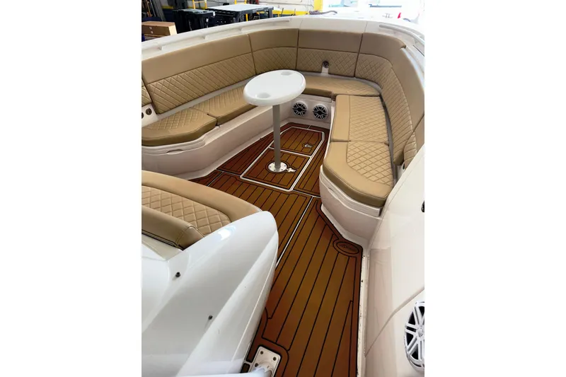 Slide: The Image of Luxurious seating area on 2019 Intrepid 345 Nomad FE boat with tan upholstery and wood flooring. - 9