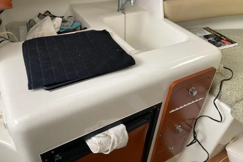 Slide: The Image of 2005 Pro-Line 30 Walkaround interior with sink, storage, and countertop. - 11