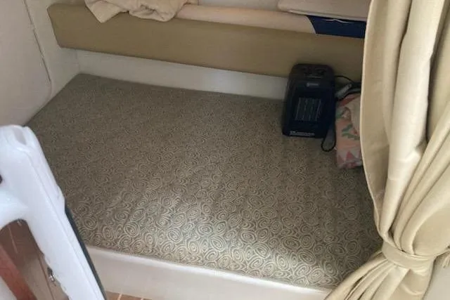 Slide: The Image of 2005 Pro-Line 30 Walkaround cabin interior with bed and heater. - 14