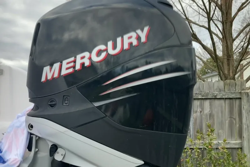 Slide: The Image of Mercury outboard motor on 2005 Pro-Line 30 Walkaround boat, wooden fence background. - 5