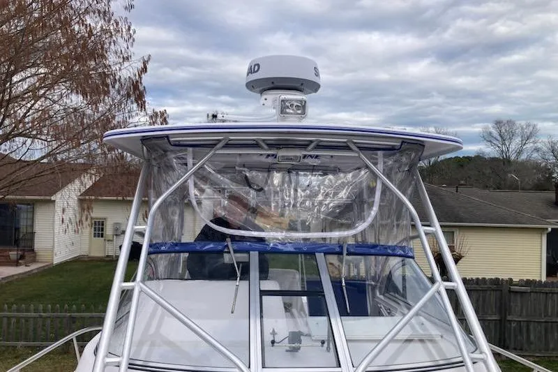 Slide: The Image of 2005 Pro-Line 30 Walkaround boat with radar, parked in a residential yard. - 7