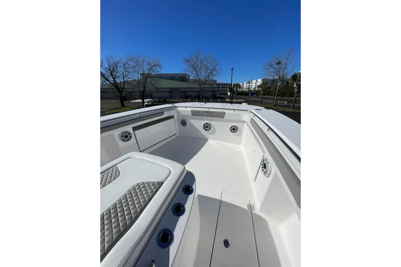 Slide: The Image of 2024 Caymas 34 CT boat interior with seating and speakers, under clear blue sky. - 15
