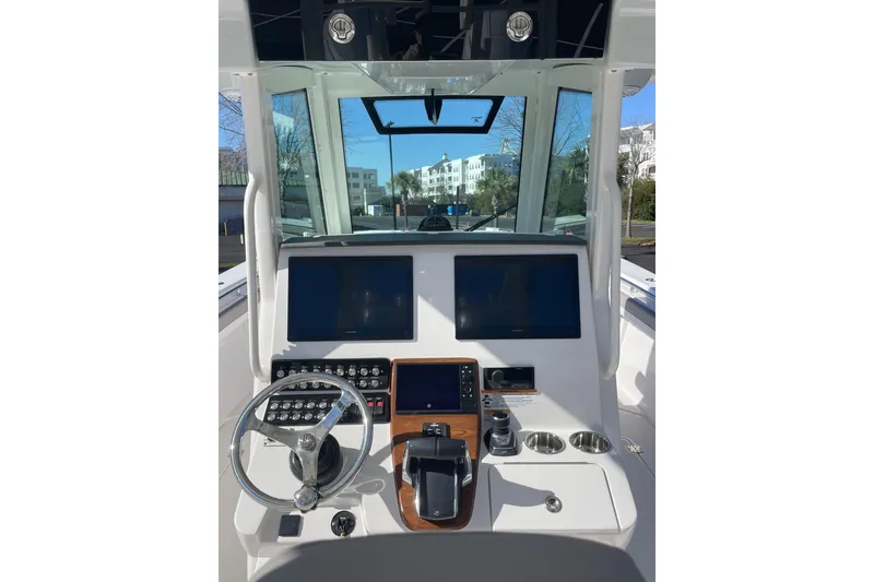 Slide: The Image of 2024 Caymas 34 CT boat helm with dual screens and modern controls. - 18
