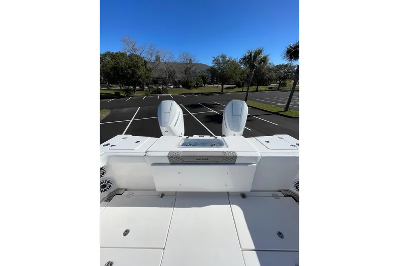 Slide: The Image of 2024 Caymas 34 CT boat with dual engines in a parking lot setting. - 22