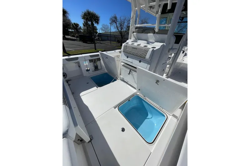 Slide: The Image of 2024 Caymas 34 CT boat interior with open storage compartments and seating. - 26
