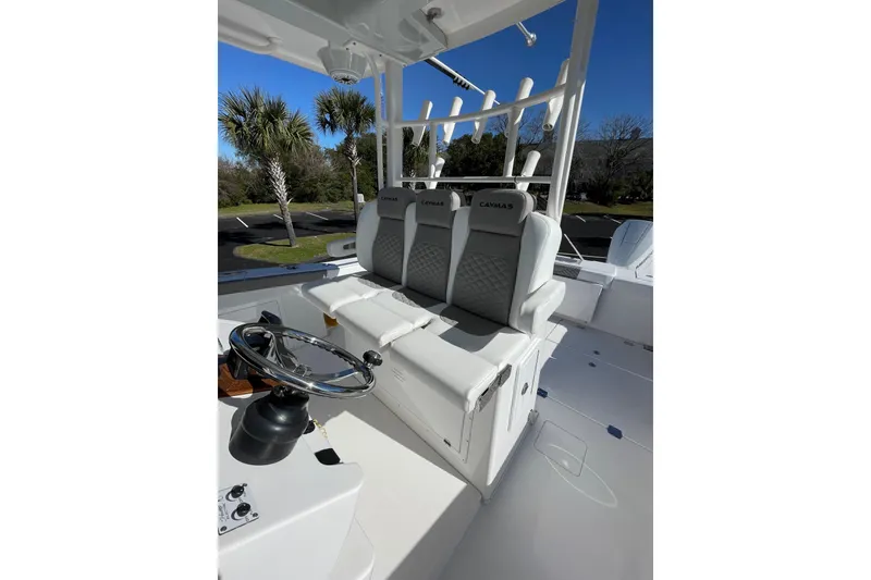 Slide: The Image of 2024 Caymas 34 CT boat interior with steering wheel and cushioned seats. - 28