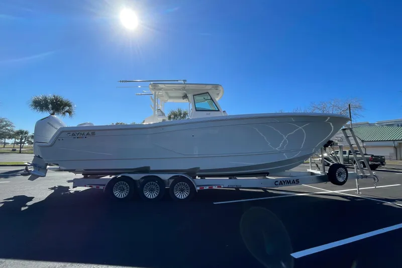 Slide: The Image of 2024 Caymas 34 CT boat on trailer under clear blue sky. - 8