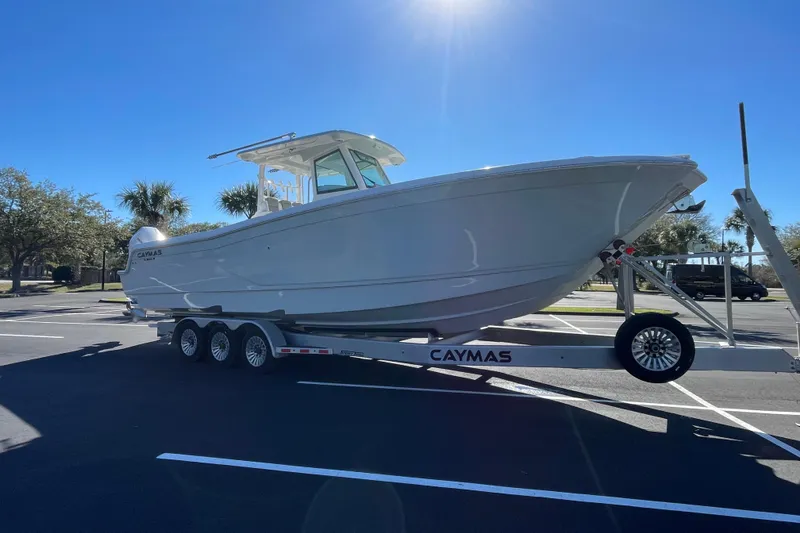 Slide: The Image of 2024 Caymas 34 CT boat on trailer in sunny parking lot. - 9