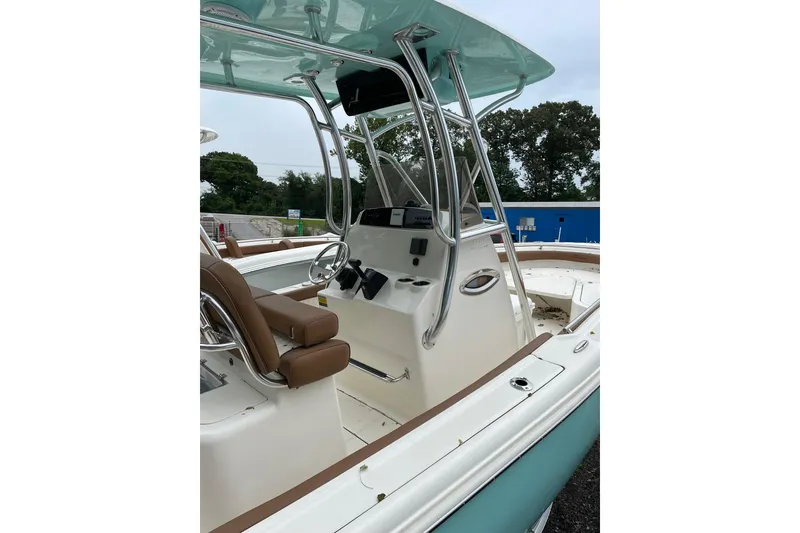 Slide: The Image of 2021 Pioneer 222 Sportfish boat interior with seating and steering console. - 2