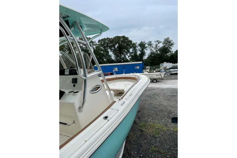 Slide: The Image of 2021 Pioneer 222 Sportfish boat in a marina, featuring sleek design and modern amenities. - 3