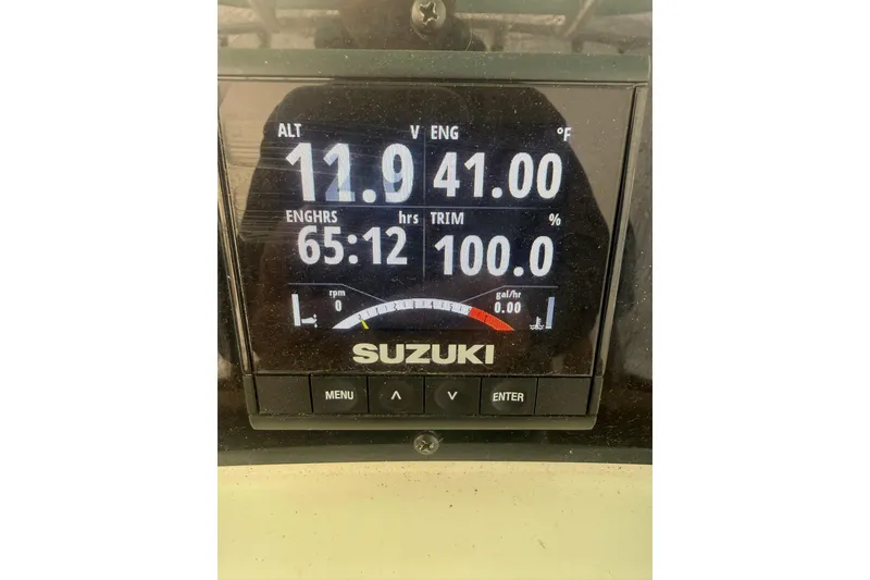 Slide: The Image of Suzuki engine display on 2021 Pioneer 222 Sportfish, showing 65.12 engine hours. - 5