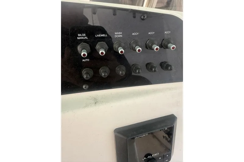 Slide: The Image of Control panel of 2021 Pioneer 222 Sportfish boat with switches and JL Audio system. - 8