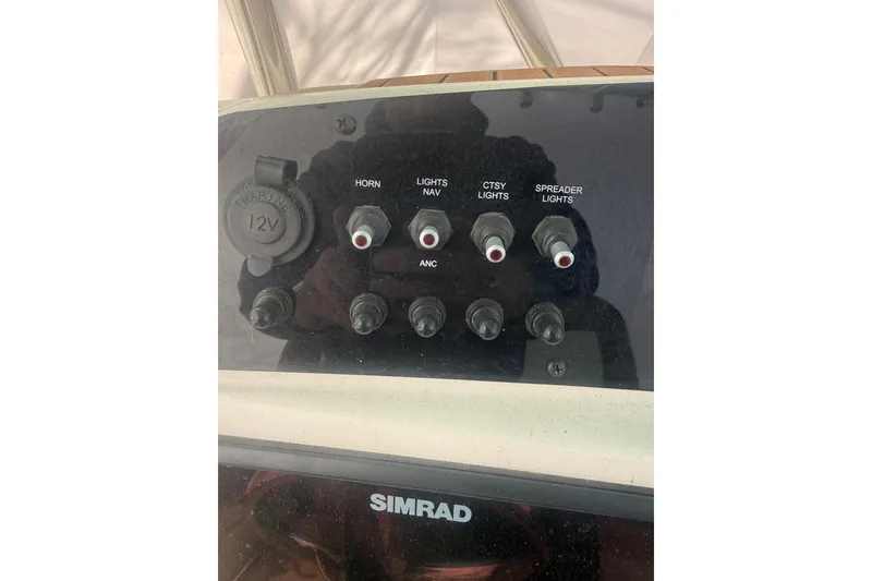 Slide: The Image of Control panel of a 2021 Pioneer 222 Sportfish boat with labeled switches. - 9